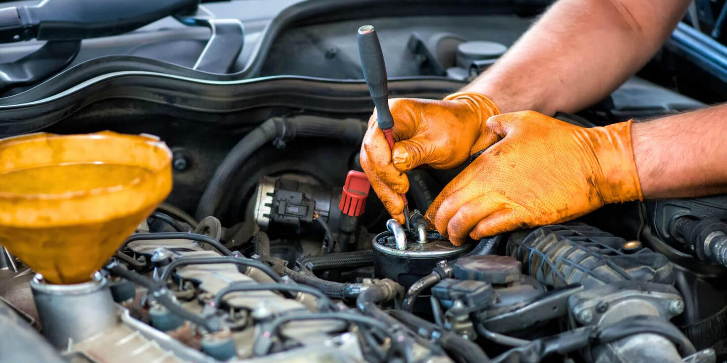 A professional technician performing car diagnostics on-site in Windsor.