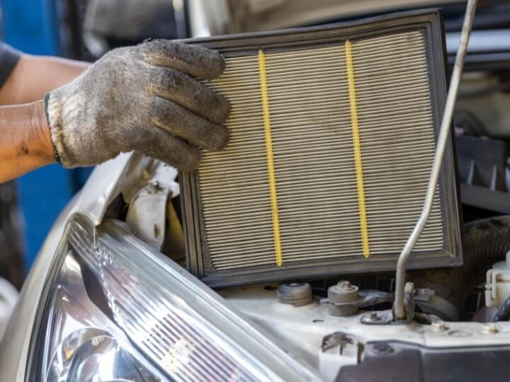 Air filter replacement during mobile servicing – Maxamy Autocare in Berkshire Mechanic performing air filter replacement as part of full or interim servicing in Slough, Maidenhead, and surrounding areas.