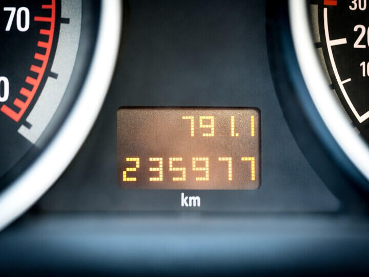 High Mileage Dashboard Reading - Used to Push Unneeded Repairs Close-up of a car dashboard showing high mileage, often used by dishonest mechanics to scare customers into repairs.