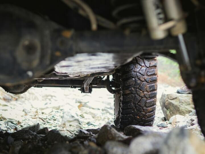 Vehicle Suspension Problems Causing MOT Fail Underneath a vehicle showing worn suspension system leading to MOT test failure